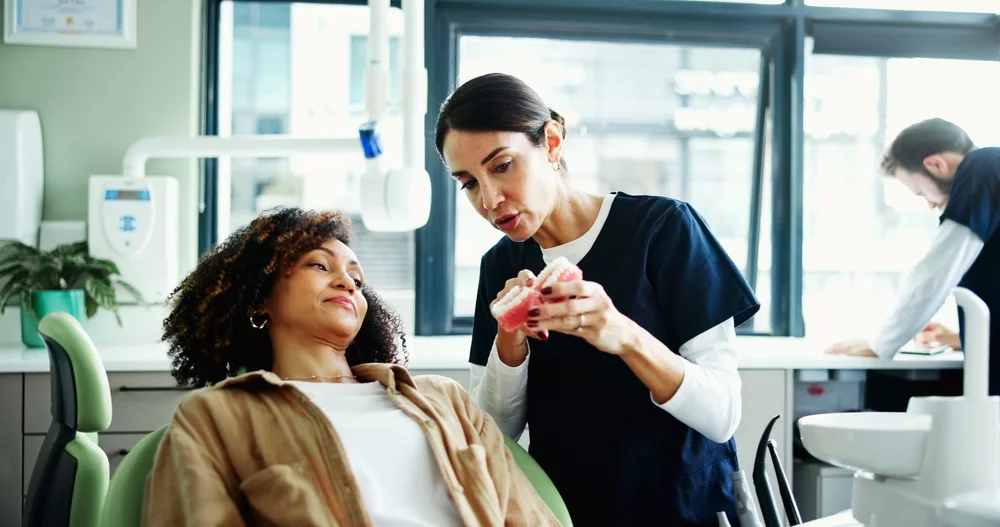 Dentis and patient consultant discussing third molar extraction