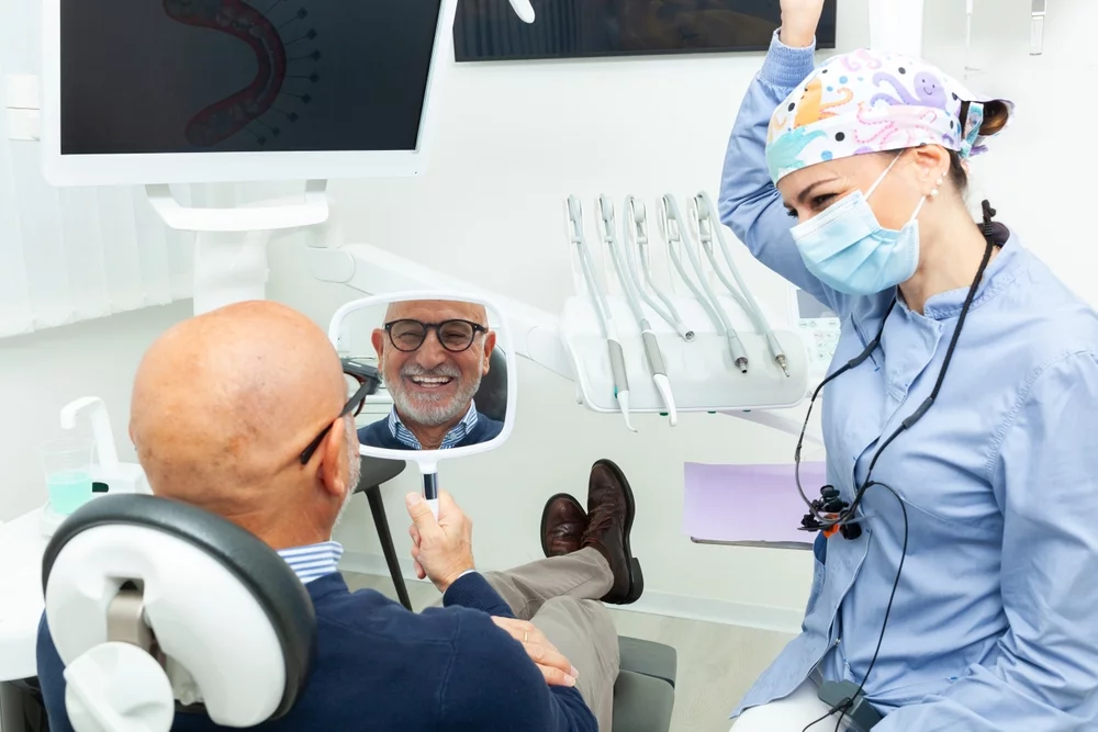 A man looks at his dental implants