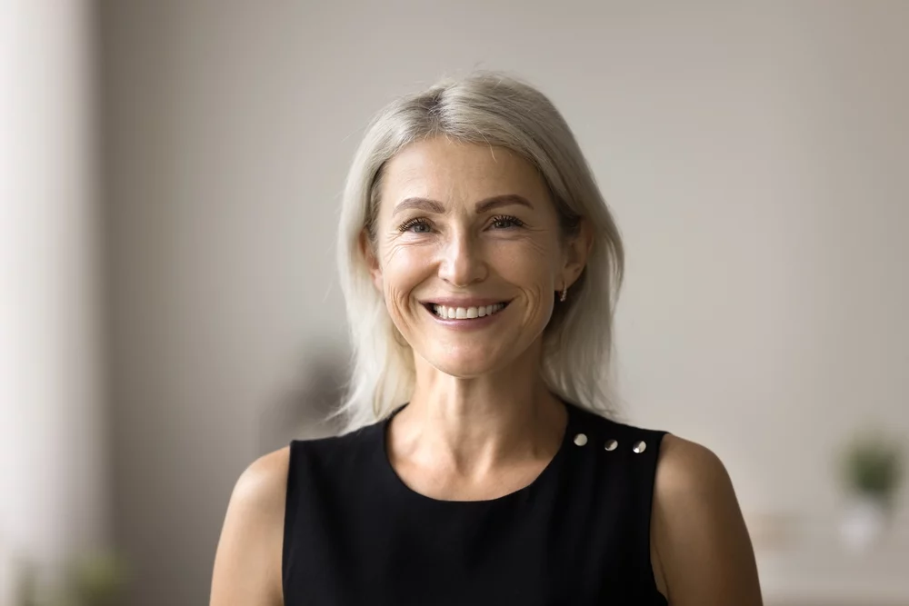 Happy, smiling senior woman in a black tank top
