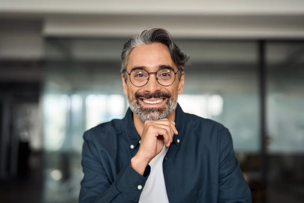Happy, middle aged man with glasses, smiling