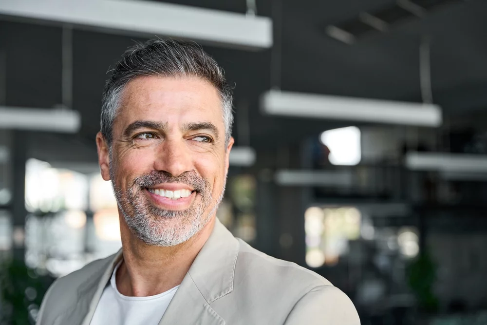 Middle aged man smiling in an office setting